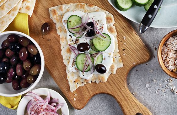Tameez bread with cream cheese, cucumbers, olives and lime-pickled onions