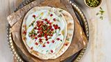 Arabic bread with cheese, honey, pomegranate seeds and pistachios