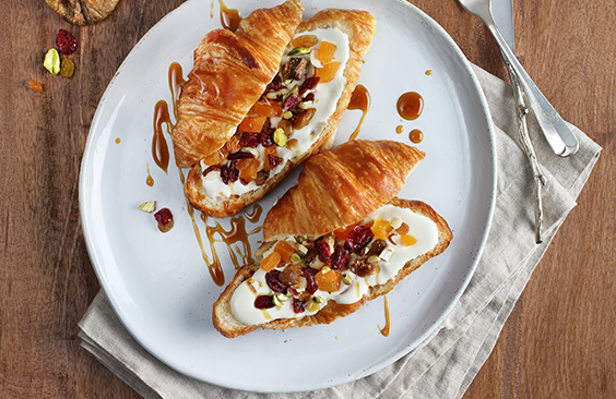 Croissants with cream cheese, dried fruits and nuts