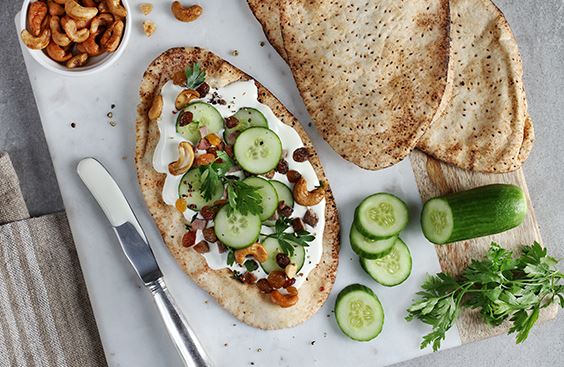Arabic bread with cream cheese, beef, cucumbers, parsley, raisins and caramelized cashews