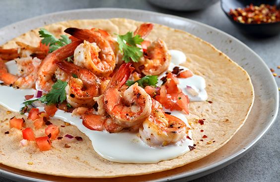 Tortilla wraps with cream cheese, grilled shrimps and salsa