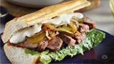 Baguette with steak, pickles and caramelized onions