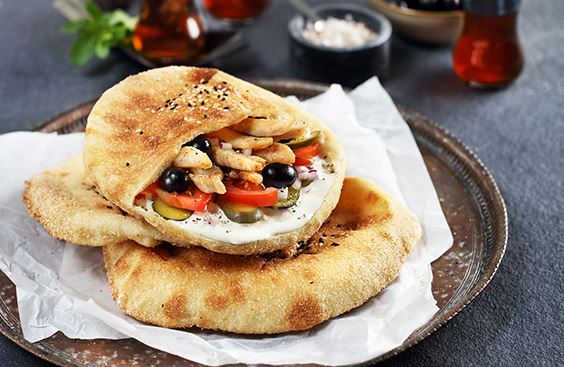 Arabic bread with cream cheese, chicken strips and vegetables