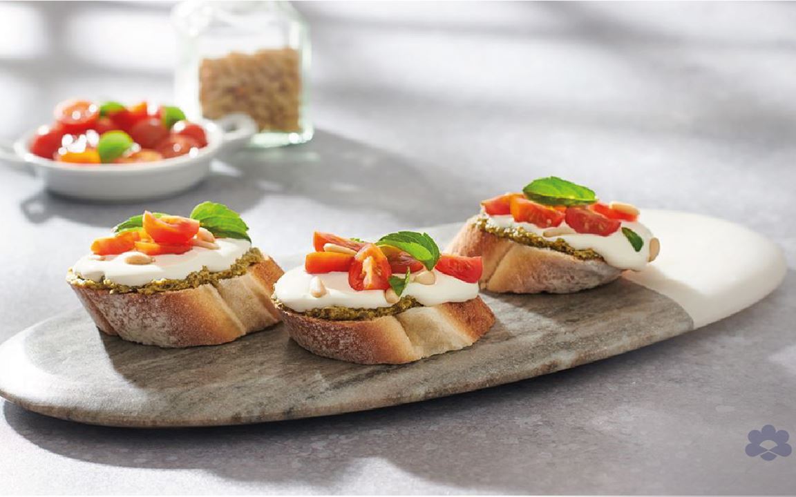 European bread with pesto, cream cheese, cherry tomatoes and pinenuts