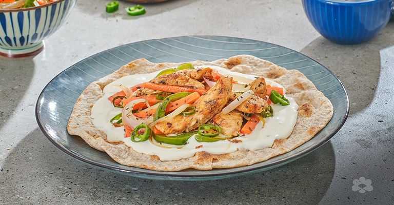 Chapatti bread with cream cheese, chicken strips and vegetables