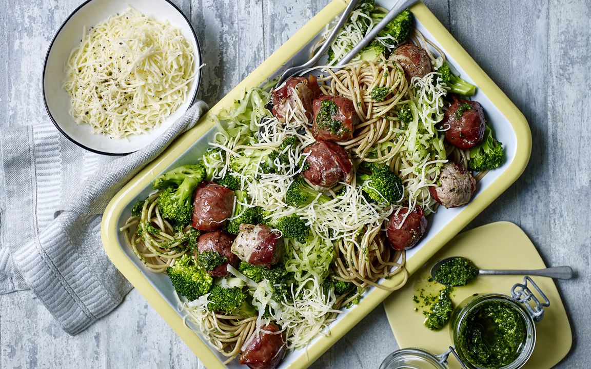 Spaghetti with parsley pesto and meatballs wrapped in prosciutto