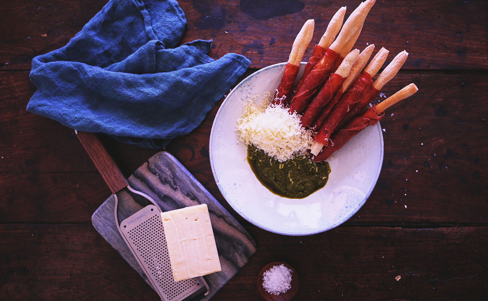 Bresaola wrapped grissini with Cheddar and basil sauce