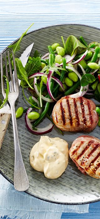 Grilled tenderloin medallions with prosciutto and edamame and bean salad