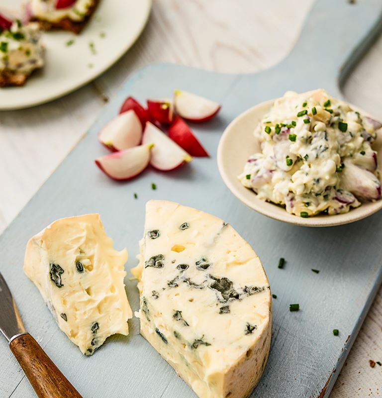 Castello Creamy Blue with radishes, chives served  on crispbread