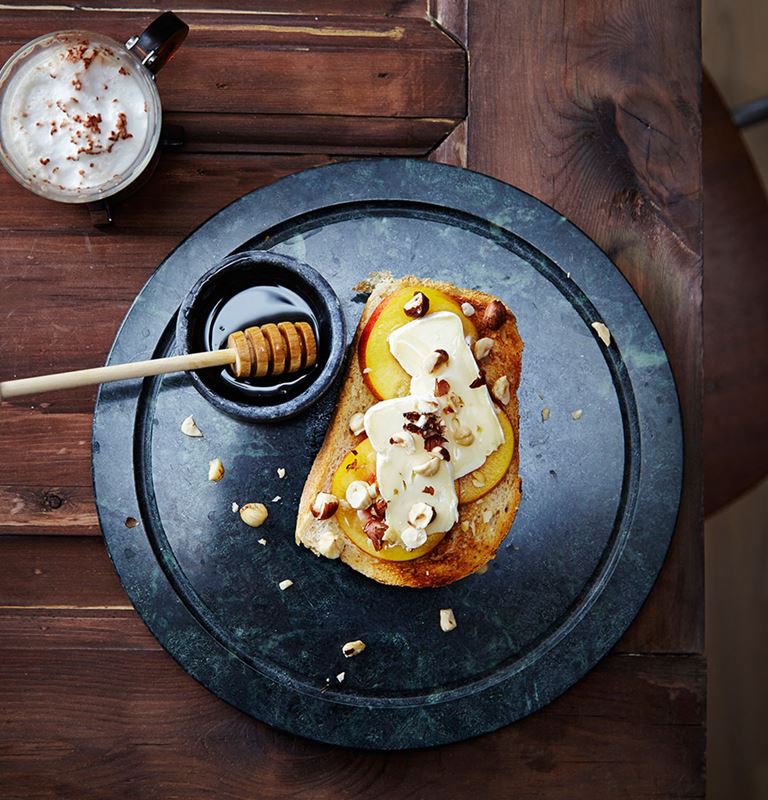 Open breakfast sandwich with Castello Extra Creamy Brie, fresh apricots and hazelnuts