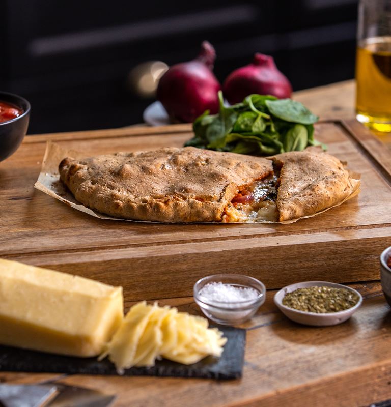 calzone with spinach, sun-dried tomato and onion