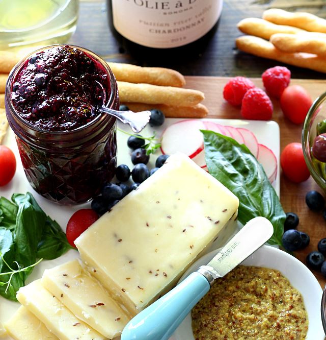 Simple cheese board with double berry chia seed jam