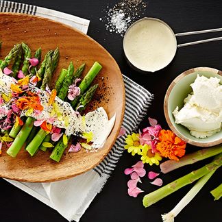 Green asparagus with cream cheese, flowers and charred spring onions