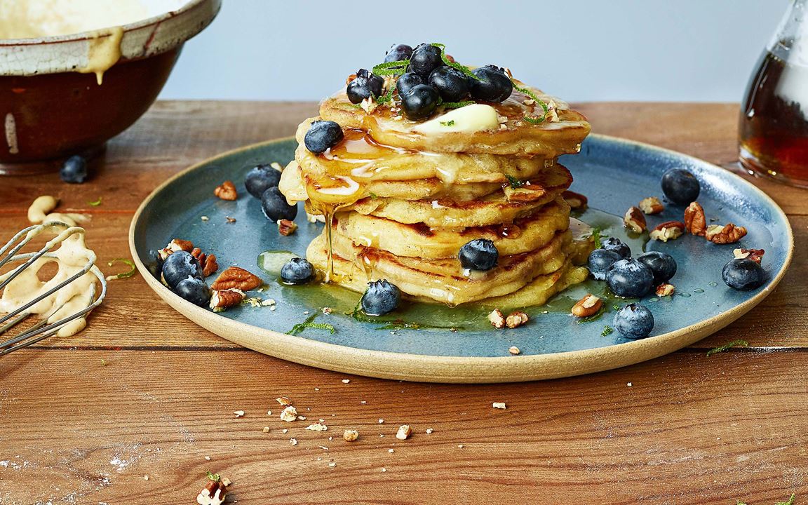 Lime spiked pancakes topped with blueberries, pecans, maple syrup